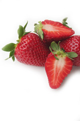 Whole and half strawberries isolated on white background