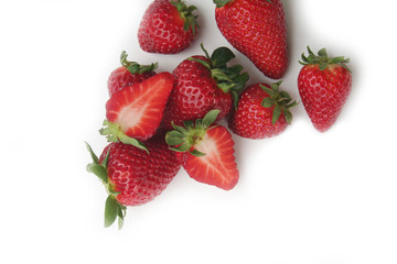 Whole and half strawberries isolated on white background