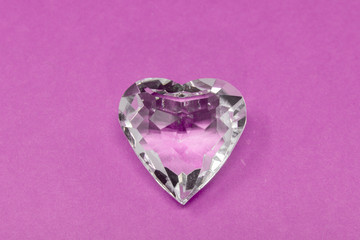 A glass diamond set against a brightly coloured background