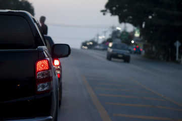 Fototapeta na wymiar Cars break on the road by traffic jam on evening.