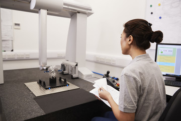 Female Engineer Uses CMM Coordinate Measuring Machine In Factory