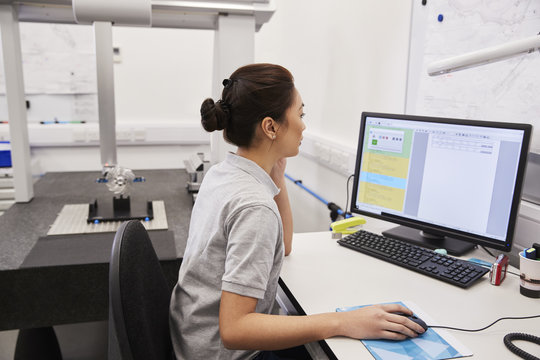 Female Engineer Uses CMM Coordinate Measuring Machine In Factory