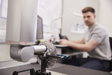 Male Engineer Uses CMM Coordinate Measuring Machine In Factory