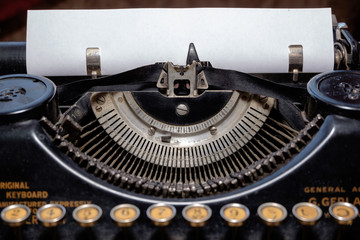 typewriter with blank sheet of paper