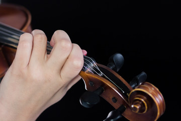 Female hand on fretboard violin. Fingers clamp the strings. For coverage of music news. Close up....