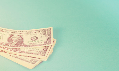 Concept savings, finances, economy . One dollars banknotes isolated on blue backround. Toned.