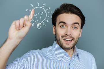 Unusual idea. Positive happy manager putting his finger up while getting a brilliant idea