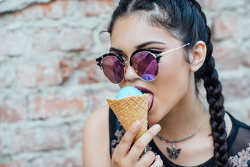 A young pretty girl sitting ladder and taste ice cream