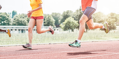 Athletes running on athletic race track - Runners sprinting at training session