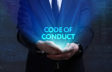 Business, Technology, Internet and network concept. Young businessman working on a virtual screen of the future and sees the inscription: Code of conduct