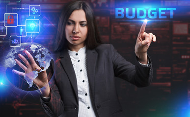 The concept of business, technology, the Internet and the network. A young entrepreneur working on a virtual screen of the future and sees the inscription: Budget