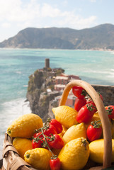 Lemons and tomatos fruits with Doria castle in Vernazza - La Spezia