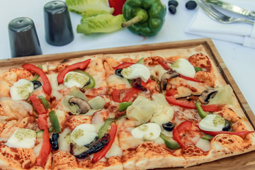 Margherita italian pizza with melted mozzarella cheese and tomato garnished with fresh basil