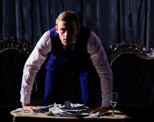 Serious young man, businessman, boss leaning on table