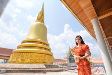 lady and temple in Thailand