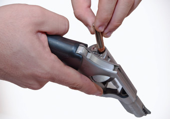 Two hands shown loading a .357 magnum revolver