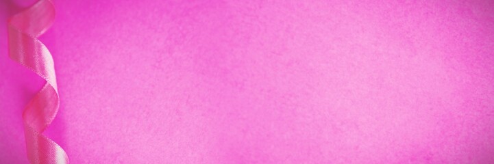Pink ribbon on pink background