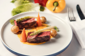 Grilled medium rare steak vegetables on plate