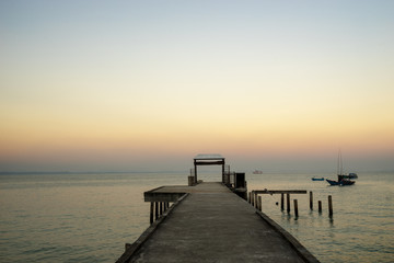 Fototapeta na wymiar sunset time with ocean dock and fisherman boat