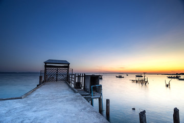 Fototapeta na wymiar scenic of surise on seascape and ocean dock in twilight sky