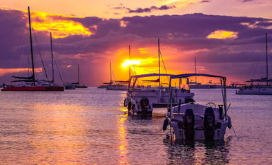 Boats in a beautiful sunset at Bayahibe beach in the Caribbean Sea.