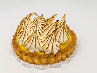 Isolated, close-up of a lemon meringue tart, with peaks