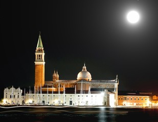 Church of Saint Geroge in Venice by night and the bright trails left by the passing ships with moon