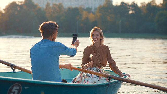 Smiling young couple in a boat