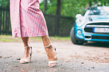 Tidy tanned soft woman feet in high-heeled peep-toes