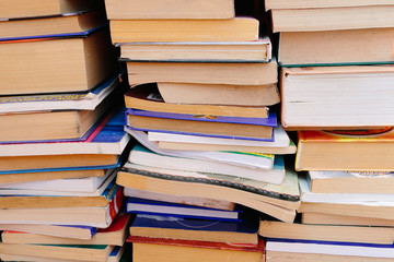 Stack of books background. many books piles.