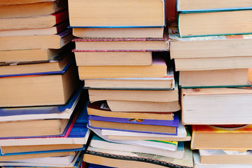 Stack of books background. many books piles.