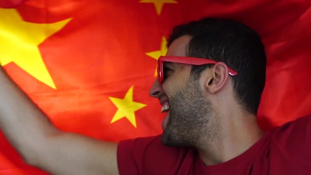 Chinese fan celebrating with flag