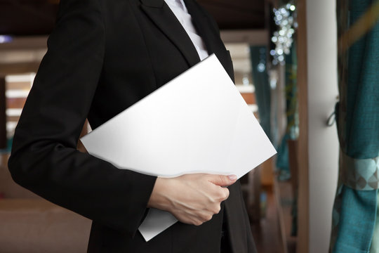 the girl holds the white magazine in hand