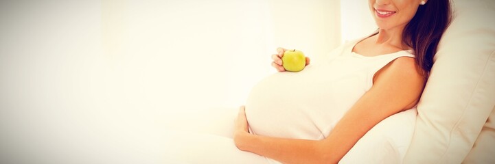Happy pregnancy with an apple on his belly 