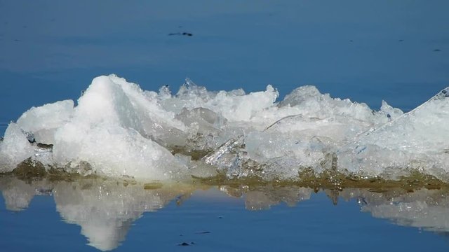 Floe large sails reflecting in the water. The debacle of the early Northern spring.