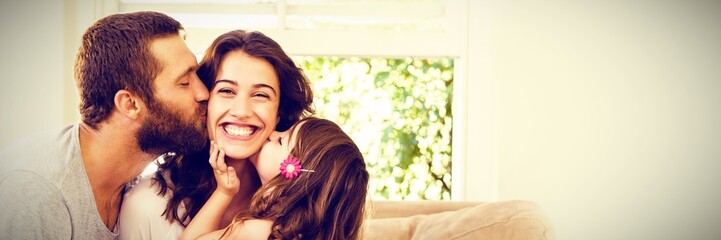 Mother receiving gift from her husband and daughter