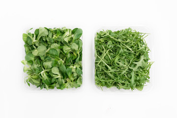 top view of iceberg lettuce and rocket salad in boxes