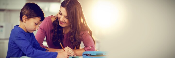Mother helping her son doing homework