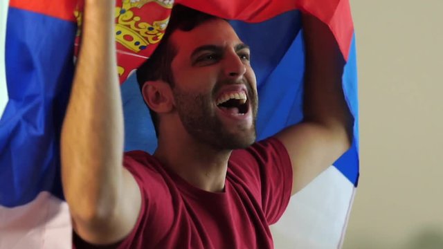 Serbian fan celebrating with flag