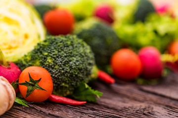 Fresh seasonal vegetables on wooden surface