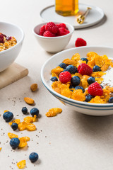 Healthy breakfast. Corn flakes with yogurt, almonds, blueberries, raspberries and chia seeds.