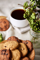 Breakfast background with mug of fresh coffee, homemade oatmeal cookies, grind coffee
