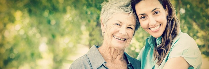 Mother and grandmother smiling in park