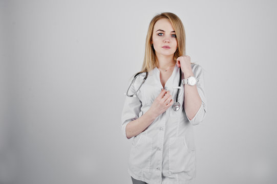 Blonde sexy doctor nurse with stethoscope isolated on white background.