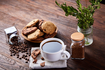 Breakfast background with mug of fresh coffee, homemade oatmeal cookies, grind coffee