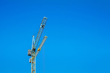 Naklejka premium Two cranes against the blue sky.