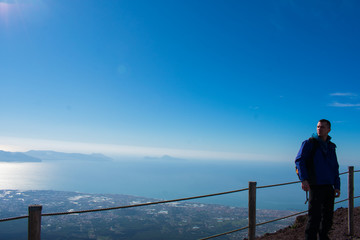 hiker in mountain and beautiful view on city from above on Vesuvius volcano 