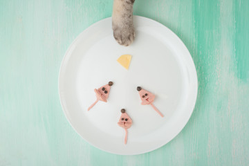 Mouse of sausages and cat's foot, a creative of food on a white plate. Food Concept