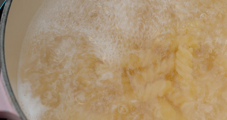 Cooking with fusilli in bowl