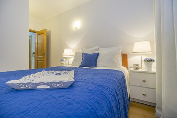 Carved wooden tray decorating elegant bedroom in white and blue